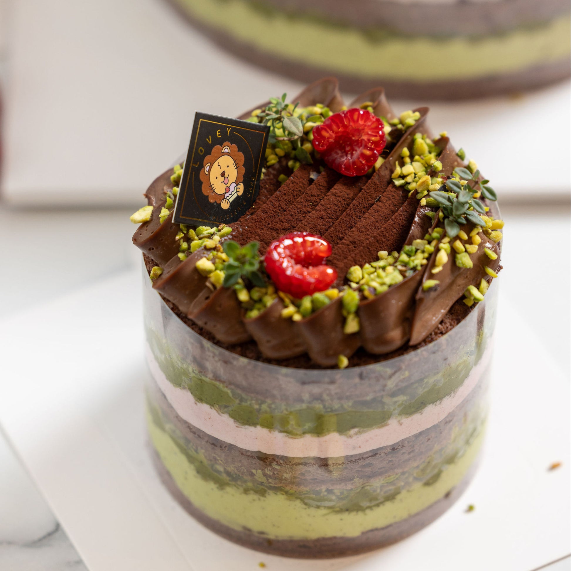 Texture close-up of layered chocolate chiffon sponge and pistachio cream in Dubai Chocolate Pistachio Shortcake.