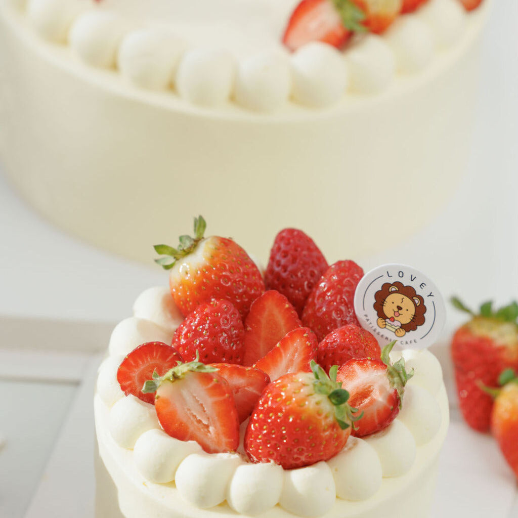 Top view of Fresh Strawberry Shortcake with ripe strawberries and cream on top