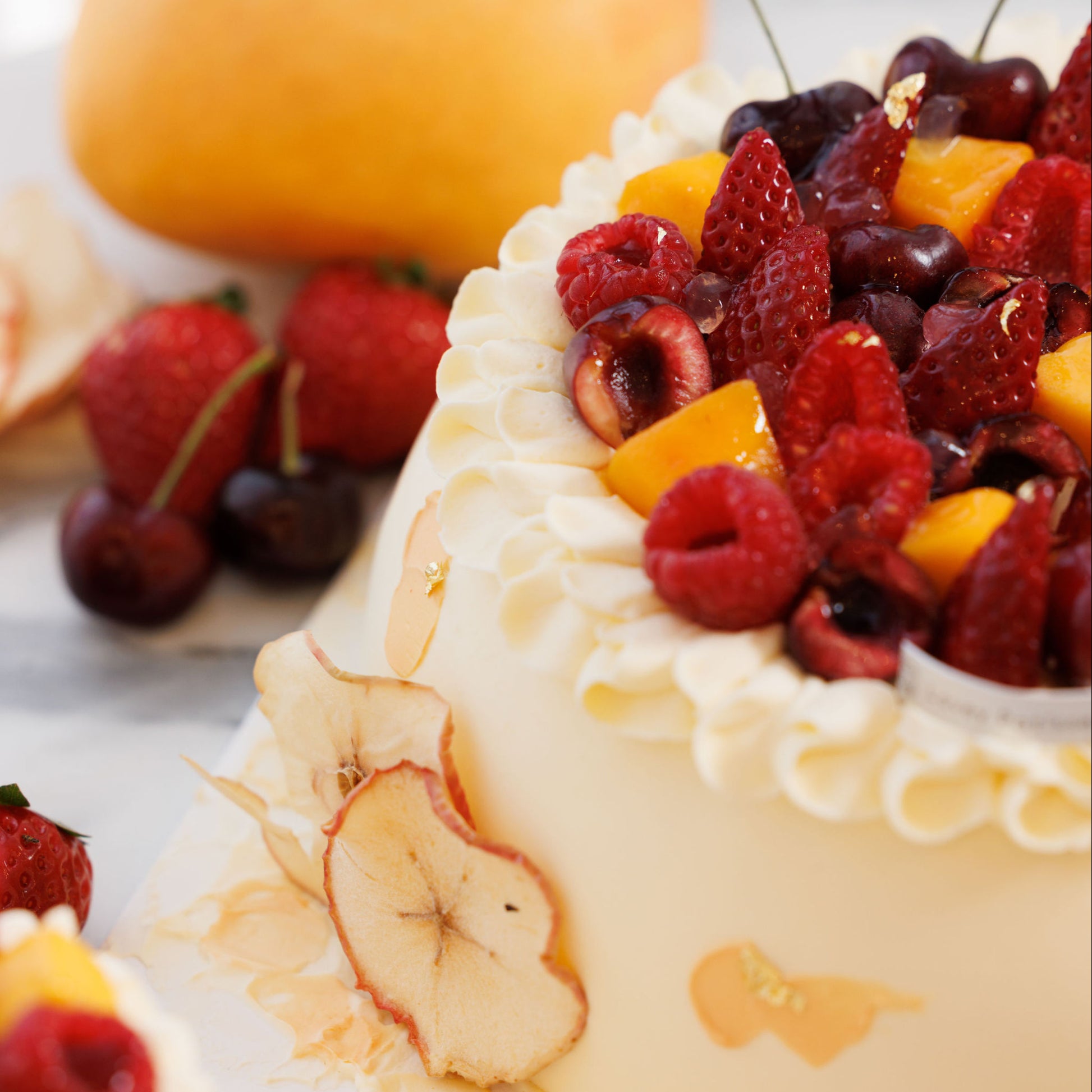 Side view of hawthorn elderflower apple chiffon shortcake showing soft sponge layers and light whipped cream.