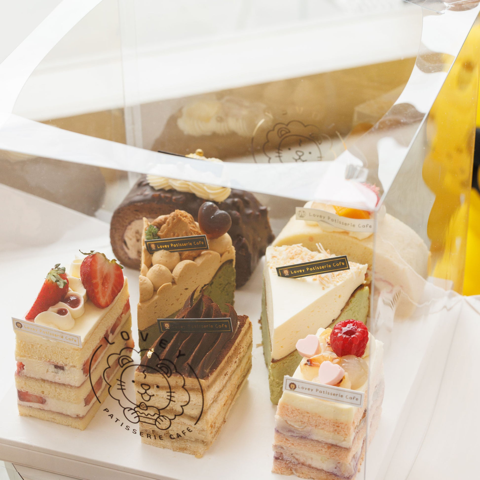 Assorted cake slices from Lovey’s Slice Family Box displayed together, including seasonal flavours
