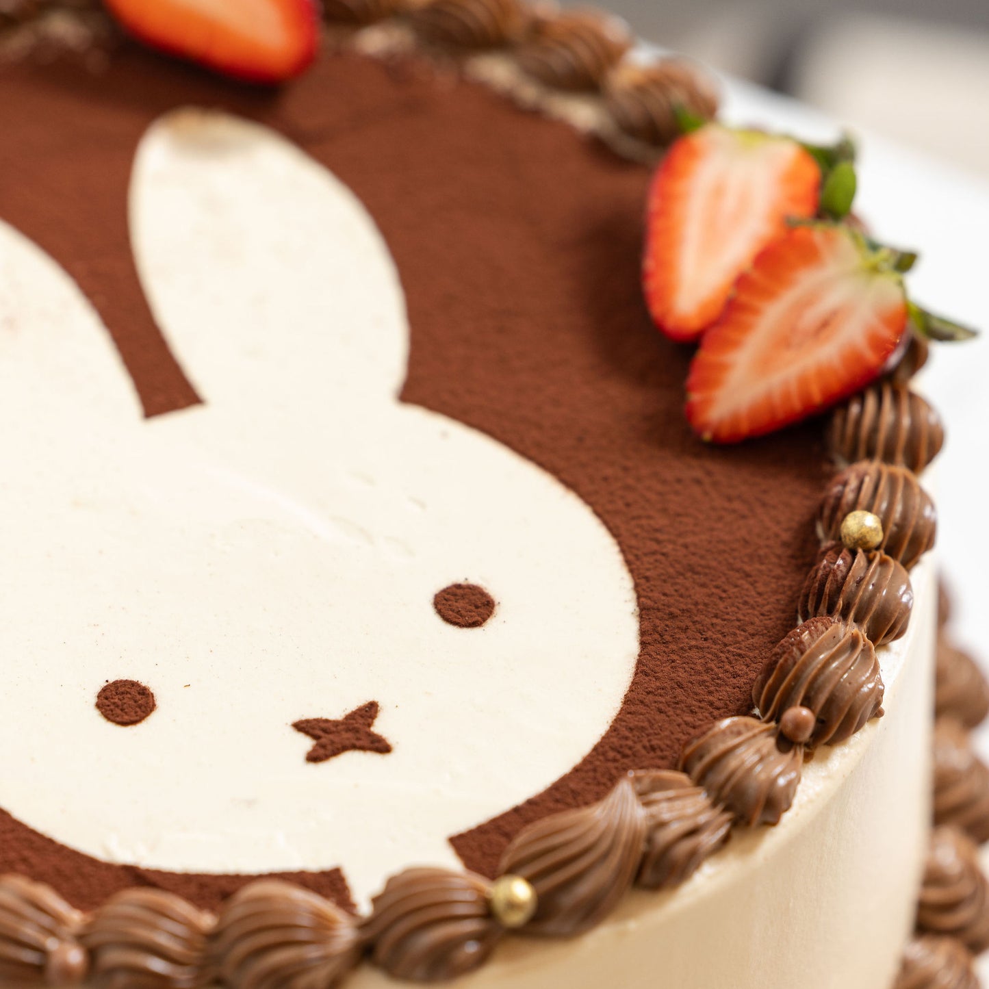 Angled view of Miffy Tiramisu Shortcake highlighting creamy tiramisu layers and dusted cocoa topping.