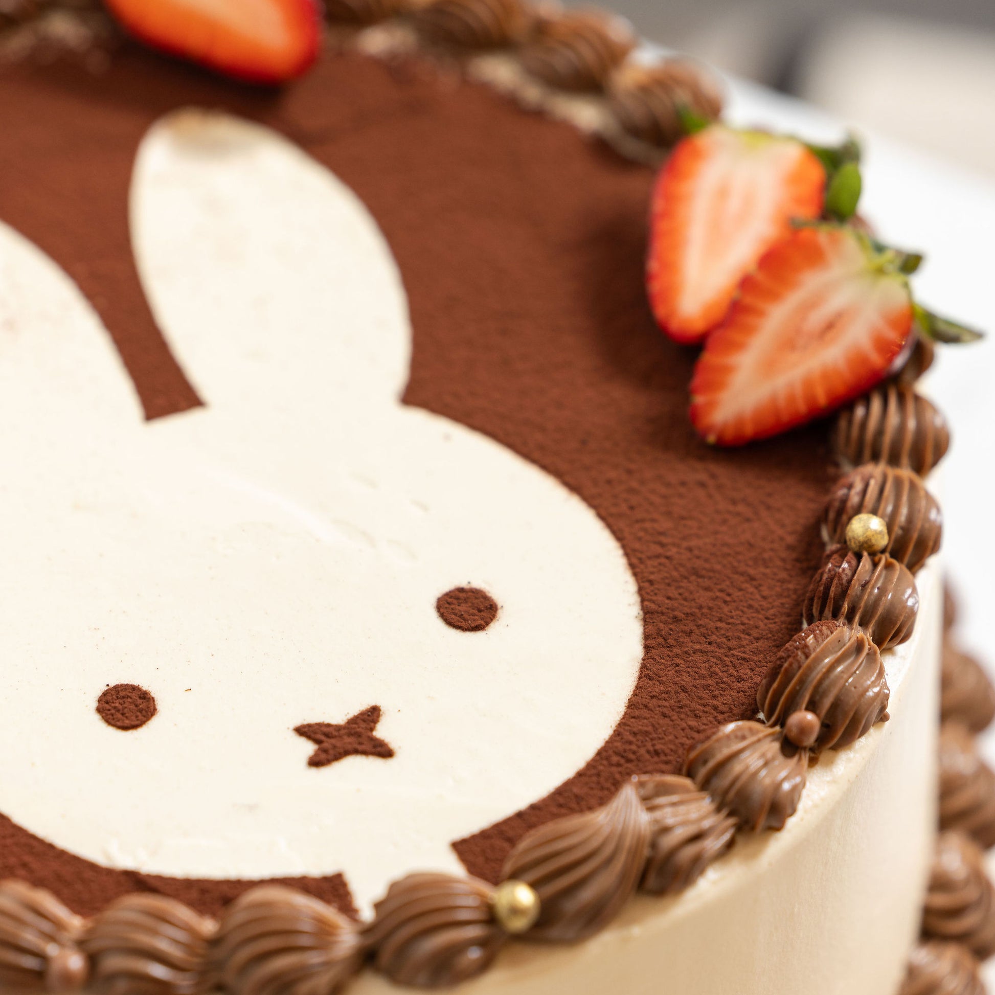 Angled view of Miffy Tiramisu Shortcake highlighting creamy tiramisu layers and dusted cocoa topping.