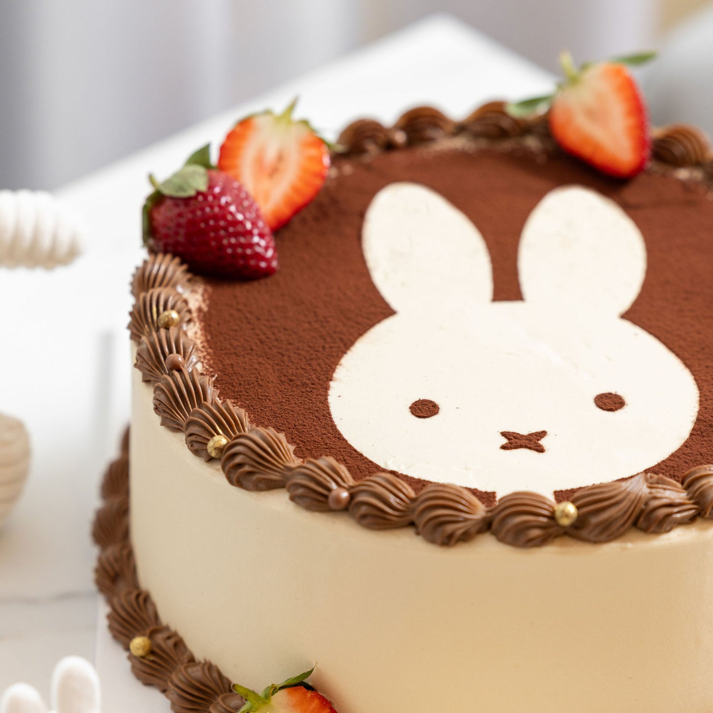 Close-up of creamy tiramisu filling and cocoa powder garnish on Miffy Tiramisu Shortcake.